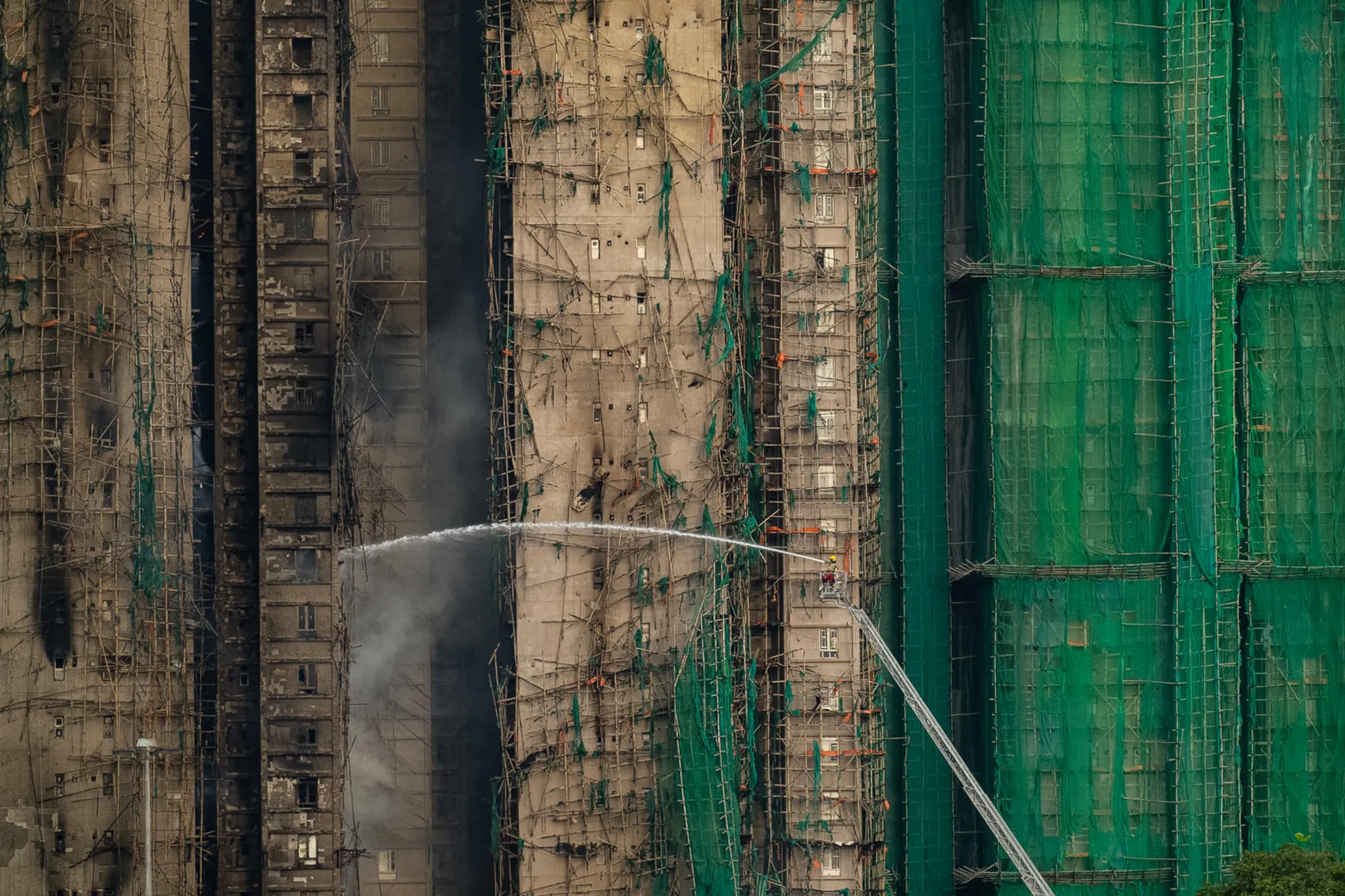 Firefighters work to control a blaze that erupted Wednesday at Wang Fuk Court, a residential complex in the Tai Po district of Hong Kong's New Territories.