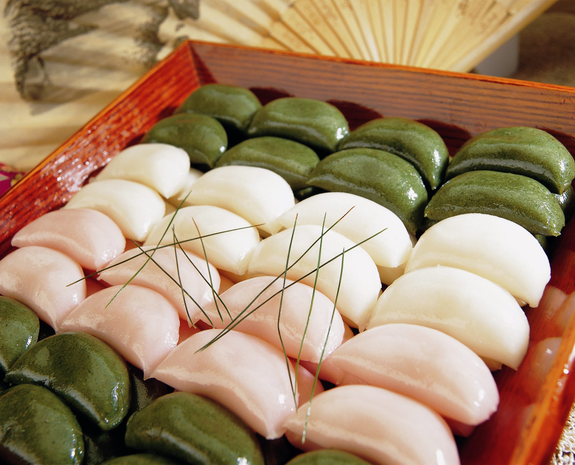 Songpyeon, a type of tteok to celebrate Chuseok. Photo via Wikimedia Commons: Public Domain