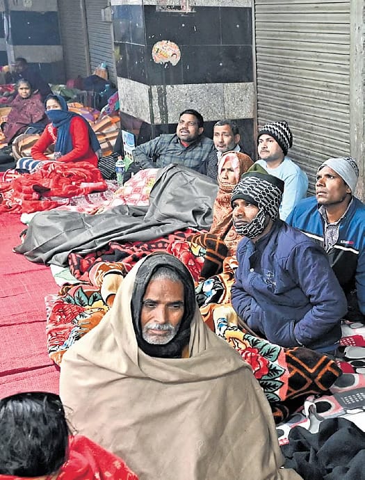 Patients and their family members resting inside a subway near AIIMS Metro station