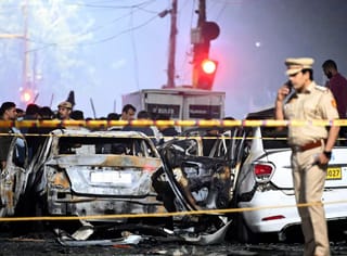 Security and investigation teams inspect the blast site near the Red Fort.