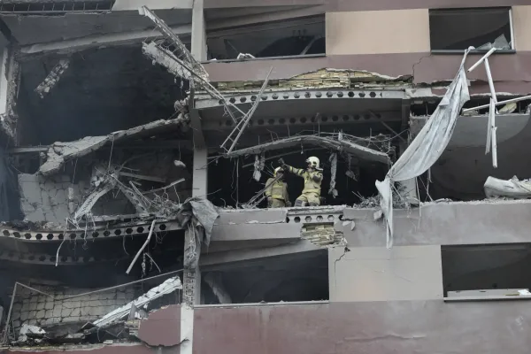 Firefighters work the scene of an explosion at a residential compound in northern Tehran, Iran,