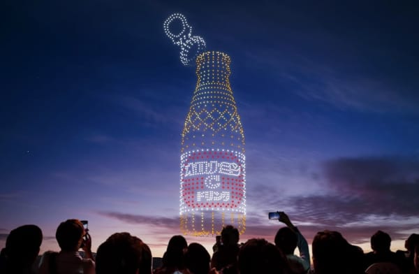 An assembly of drones recreating the structure of a bottle